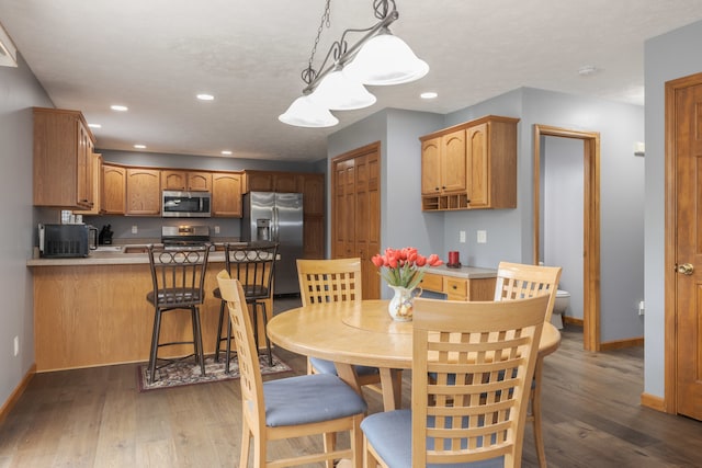 dining area with dark hardwood / wood-style floors