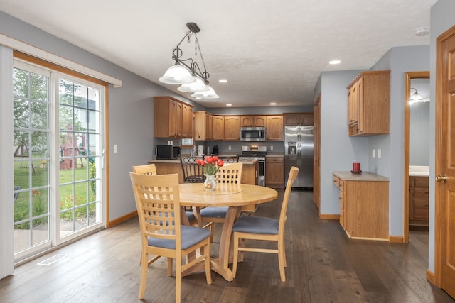 dining space featuring a wealth of natural light and hardwood / wood-style flooring