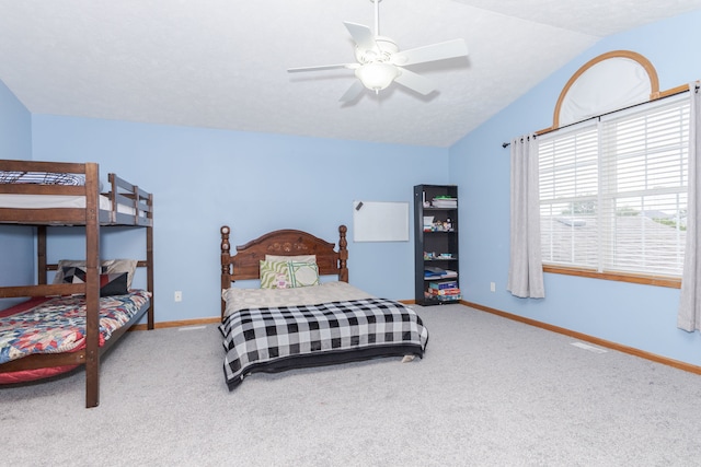 carpeted bedroom featuring vaulted ceiling and ceiling fan