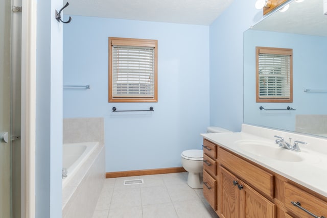 bathroom with oversized vanity, a relaxing tiled bath, tile flooring, toilet, and a textured ceiling