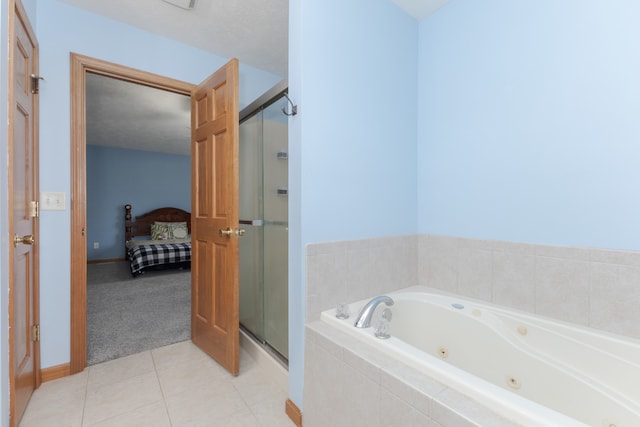 bathroom with shower with separate bathtub, a textured ceiling, and tile floors