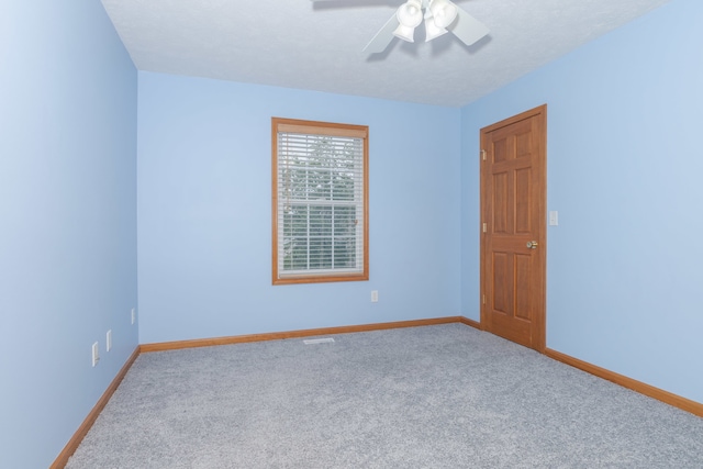 unfurnished room with ceiling fan and light carpet