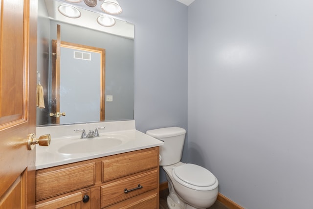 bathroom featuring oversized vanity and toilet