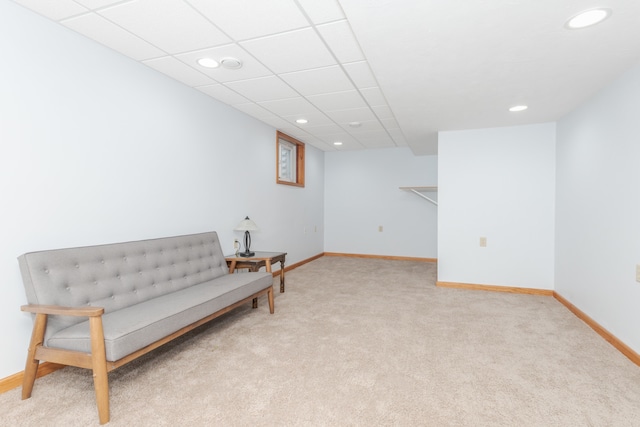 sitting room featuring light colored carpet and a drop ceiling