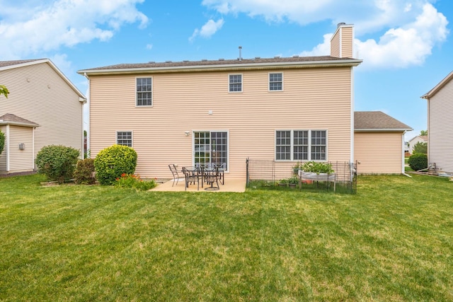 back of house with a yard and a patio area