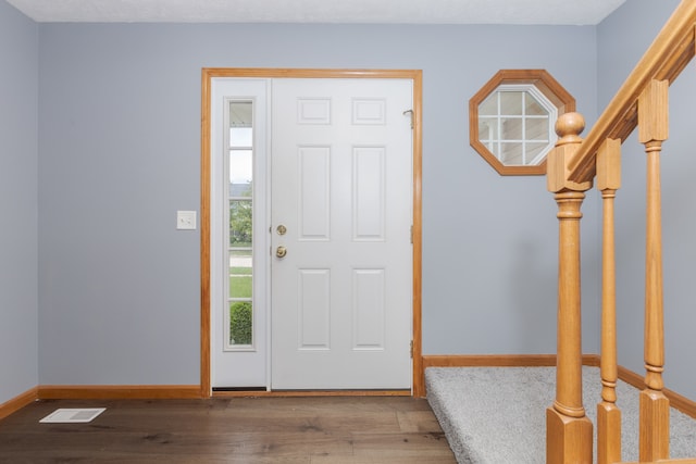 foyer entrance featuring dark hardwood / wood-style floors