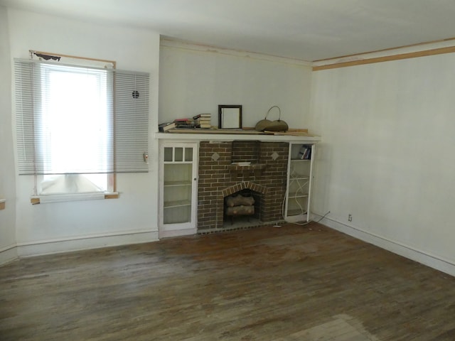 unfurnished living room with dark wood-type flooring and a fireplace