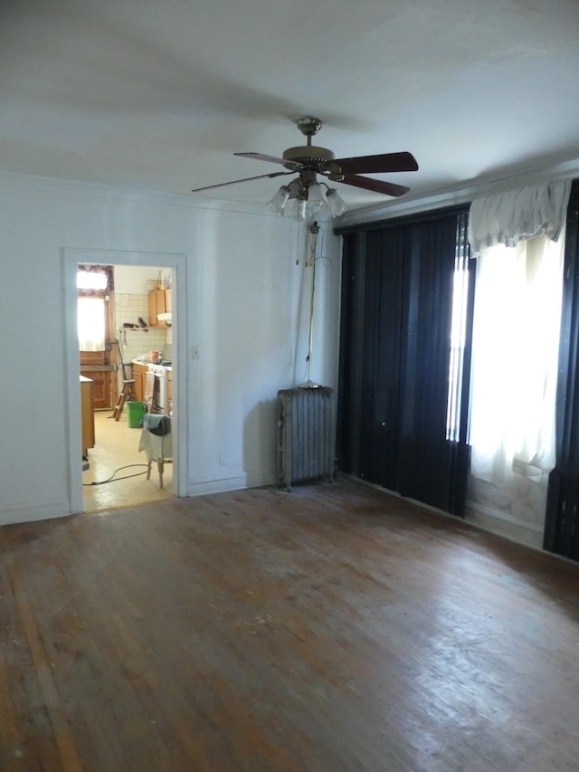 unfurnished room featuring hardwood / wood-style floors and ceiling fan