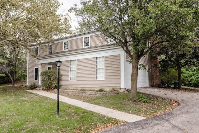 view of front of property with a front lawn and a garage