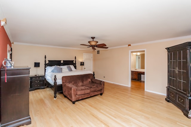 bedroom featuring light wood-type flooring, ceiling fan, ensuite bathroom, and crown molding