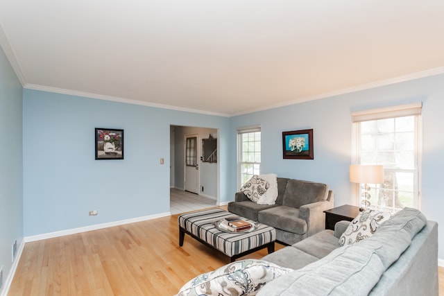 living room with light hardwood / wood-style floors and ornamental molding