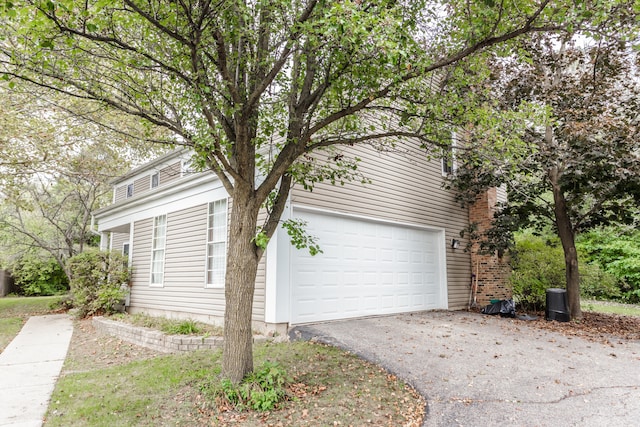 view of side of home featuring a garage