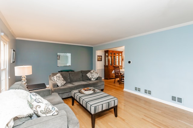 living room with crown molding and hardwood / wood-style flooring