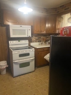 kitchen with white appliances, backsplash, and light tile flooring