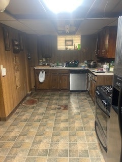 kitchen featuring a paneled ceiling, light tile floors, and appliances with stainless steel finishes