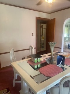 dining space featuring ceiling fan and ornamental molding