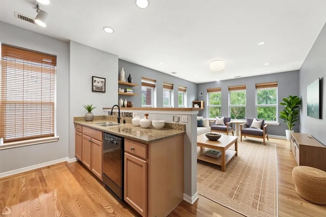 3811 S Langley Ave Unit 301, Chicago, IL 60653 - kitchen with black dishwasher, open floor plan, a peninsula, light wood-type flooring, and light stone counters