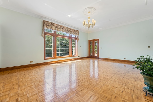 unfurnished room featuring a chandelier, light parquet flooring, and crown molding