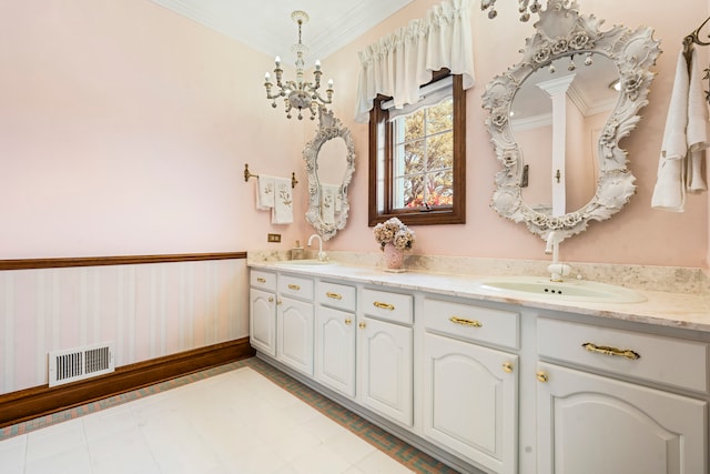 bathroom featuring vanity, an inviting chandelier, and crown molding