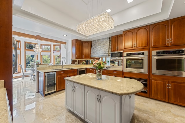 kitchen featuring wine cooler, a kitchen island, hanging light fixtures, and appliances with stainless steel finishes