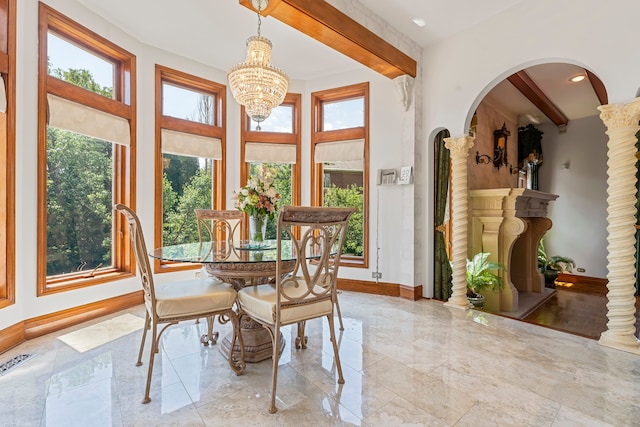 dining room featuring beam ceiling and plenty of natural light