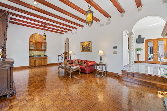 living room with beamed ceiling, parquet flooring, and french doors