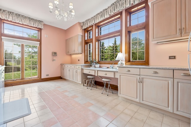 interior space featuring plenty of natural light, light tile patterned flooring, and a notable chandelier