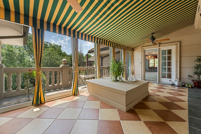 unfurnished sunroom featuring ceiling fan and lofted ceiling