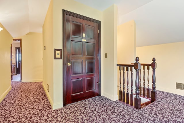 interior space with carpet and vaulted ceiling