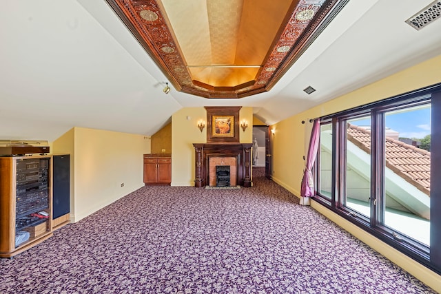 unfurnished living room with carpet flooring, lofted ceiling, wine cooler, and a tray ceiling