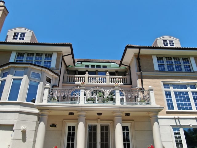 back of property with a balcony