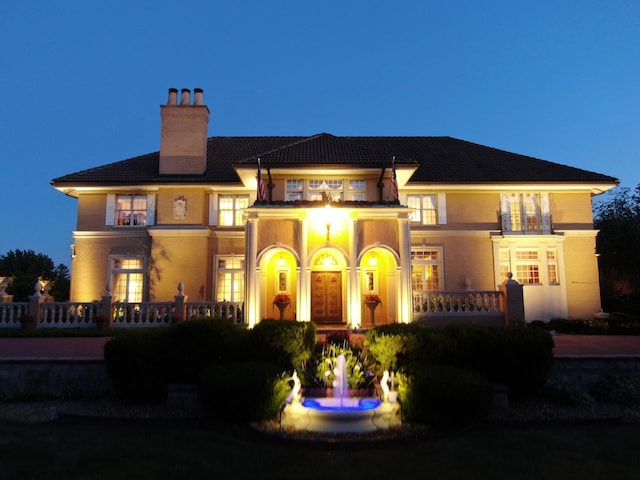 view of back house at dusk