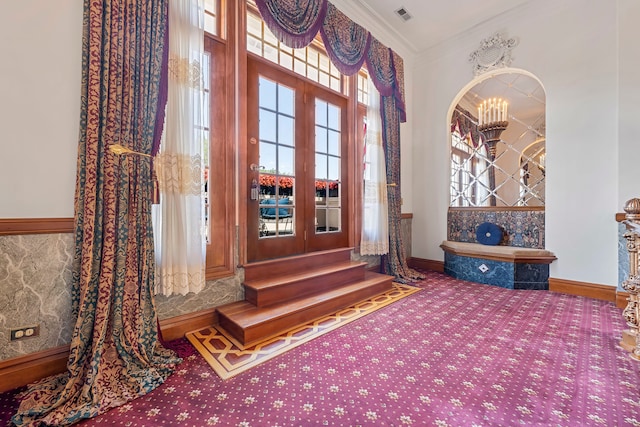 interior space featuring crown molding and a notable chandelier