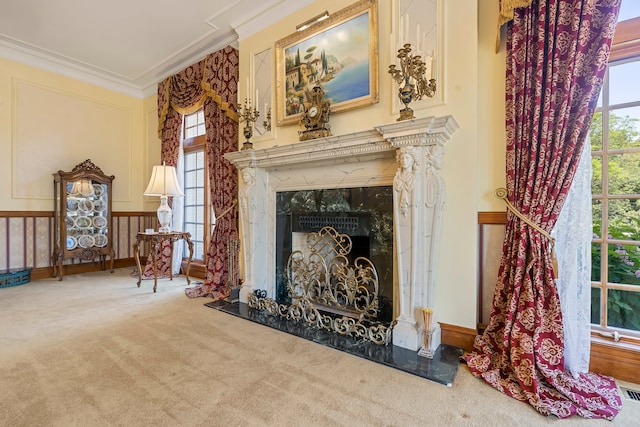 sitting room featuring a high end fireplace, carpet floors, a wealth of natural light, and crown molding