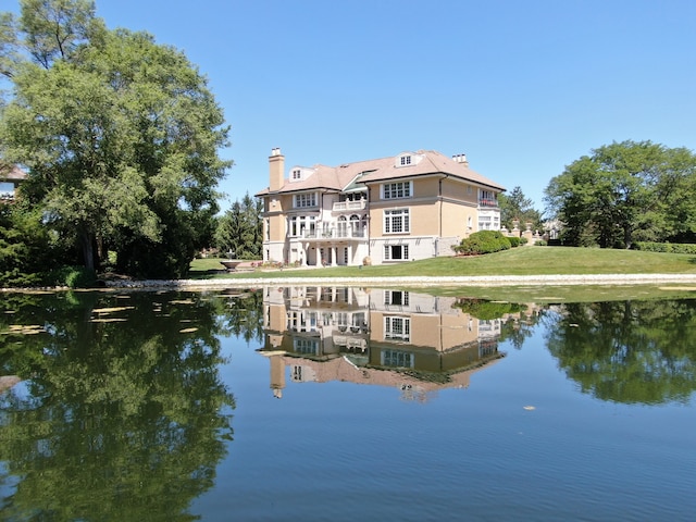 back of property featuring a water view