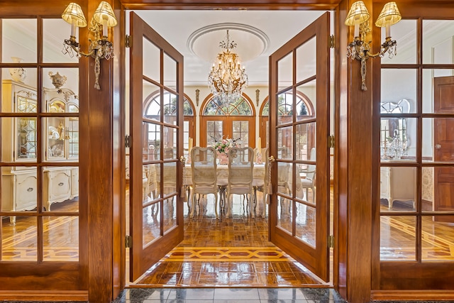 doorway with french doors and an inviting chandelier