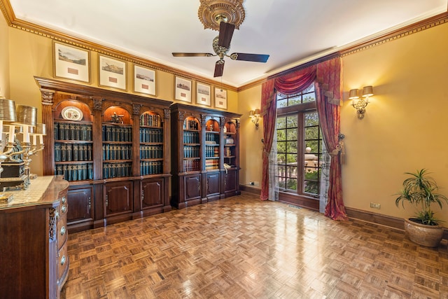 office space with dark parquet floors, ceiling fan, and ornamental molding