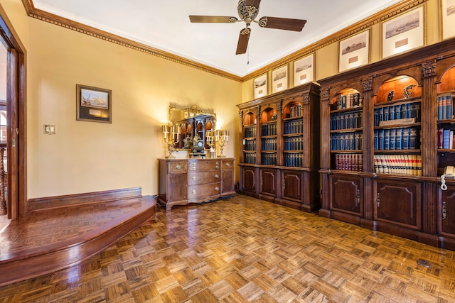 unfurnished office featuring parquet flooring, ceiling fan, and crown molding