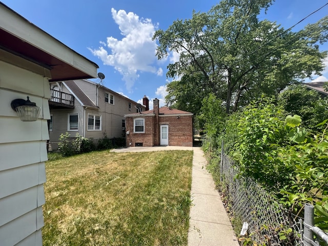 view of yard featuring a balcony and a patio area