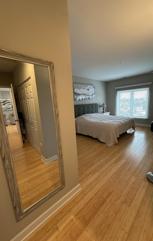 unfurnished bedroom featuring light wood-type flooring and a closet