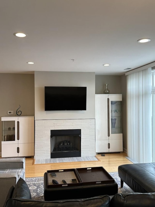 living room with light hardwood / wood-style floors and a fireplace