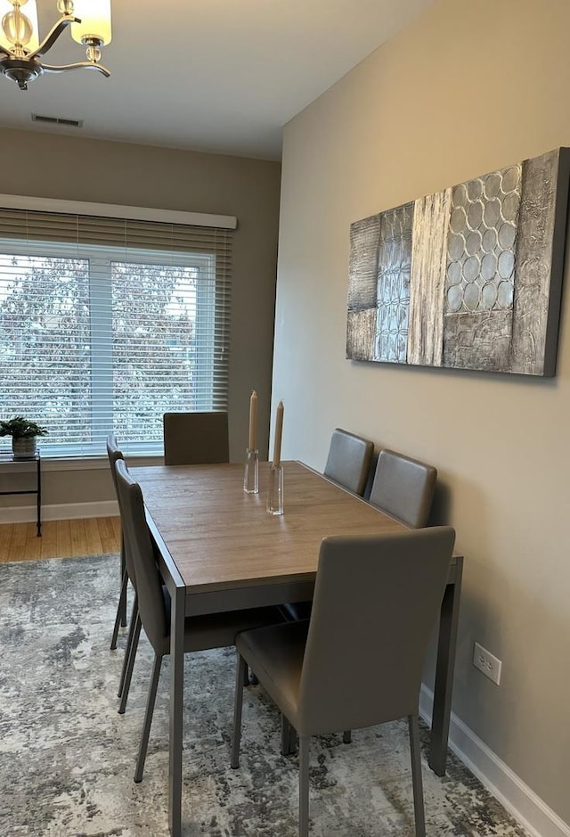 dining area featuring a chandelier and hardwood / wood-style flooring