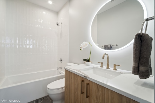 full bathroom featuring tiled shower / bath combo, tile flooring, toilet, and vanity