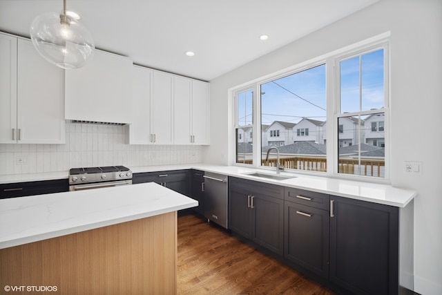 kitchen featuring appliances with stainless steel finishes, white cabinets, dark hardwood / wood-style flooring, and sink