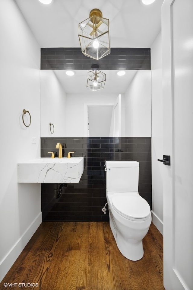 bathroom with sink, toilet, and hardwood / wood-style flooring