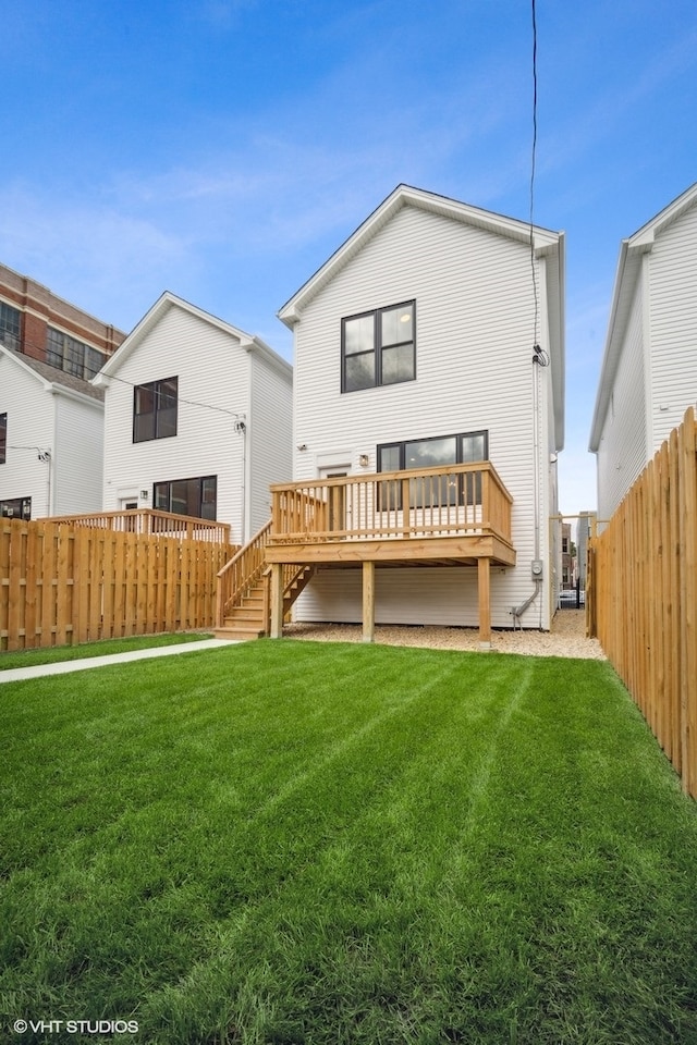 back of house with a wooden deck and a lawn