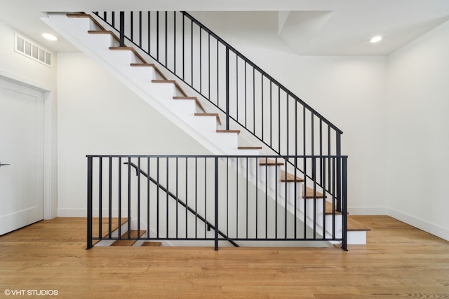 stairs with light hardwood / wood-style flooring