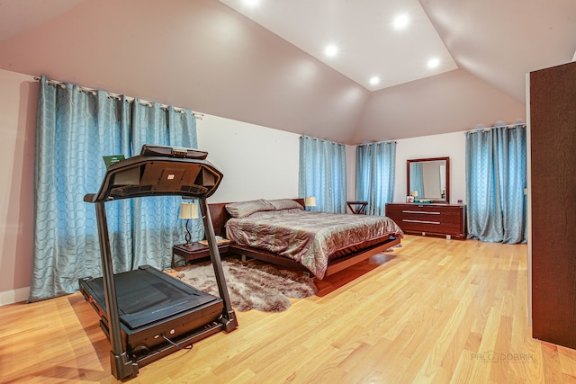 bedroom featuring lofted ceiling and light hardwood / wood-style floors