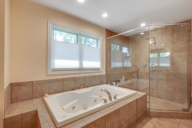 bathroom featuring tile flooring and separate shower and tub