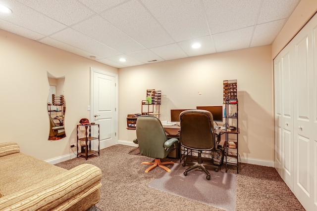 home office featuring a drop ceiling and dark carpet